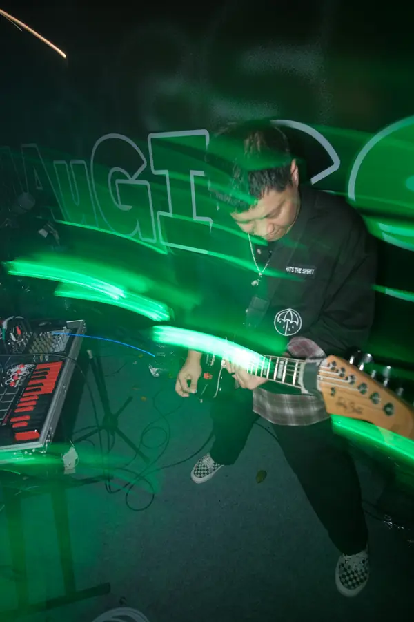 Welige on guitar with green light trails